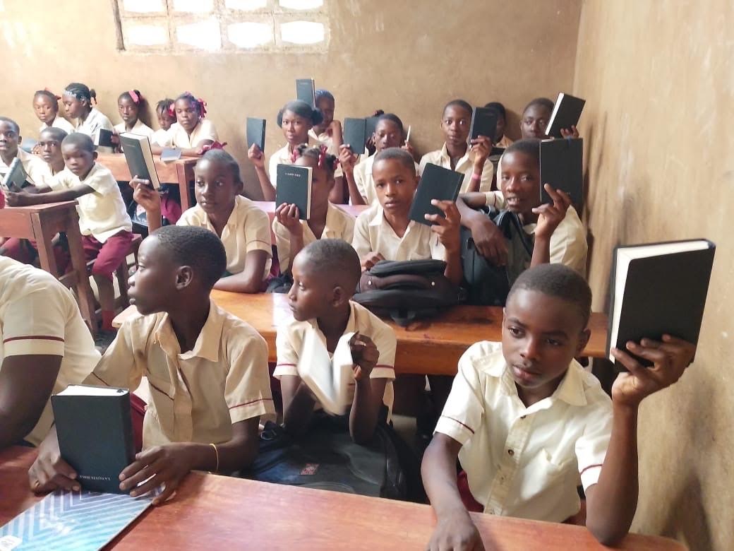 Students holding tablets in a classroom